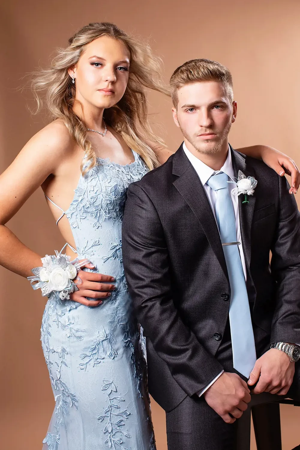 Сouple wearing a blue gown and a black suit